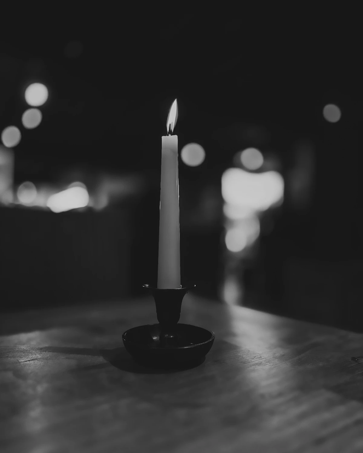 A single candle burning in a dark room